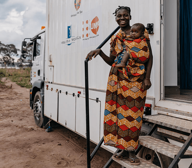 Ancha attends an appointment along with her 3-year old child at a UNFPA-supported mobile health clinic, where nurse Juliana provides her with an iron supplement.