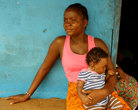 A woman holds her son.