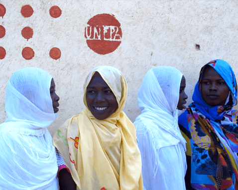 Midwifery students beneath the UNFPA banner.